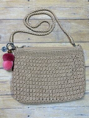 The Sak Tan Woven Crossbody with Pink Pom-Pom Charm